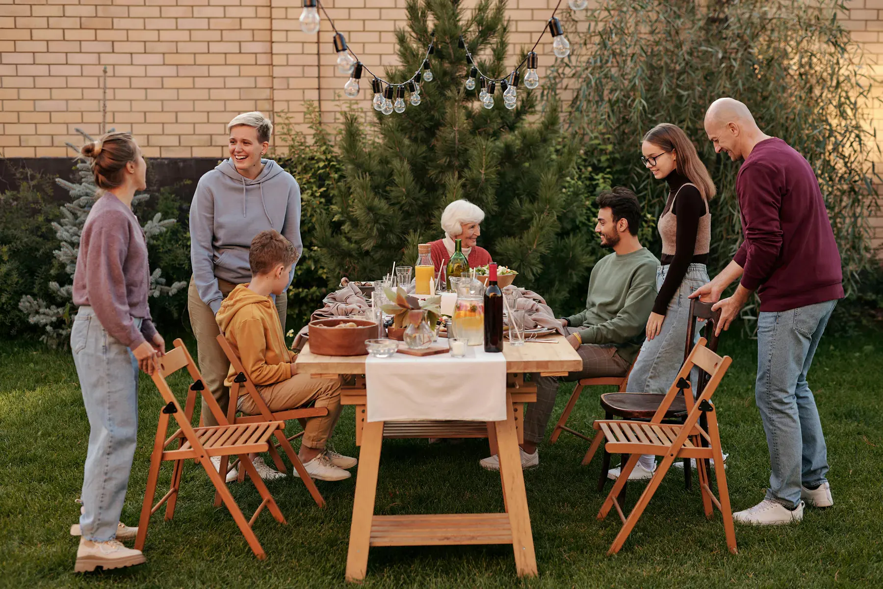 A family gathered around a table in a garden